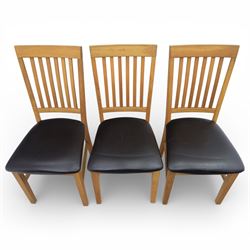 Solid light oak extending dining table with single leaf, and set of six chairs