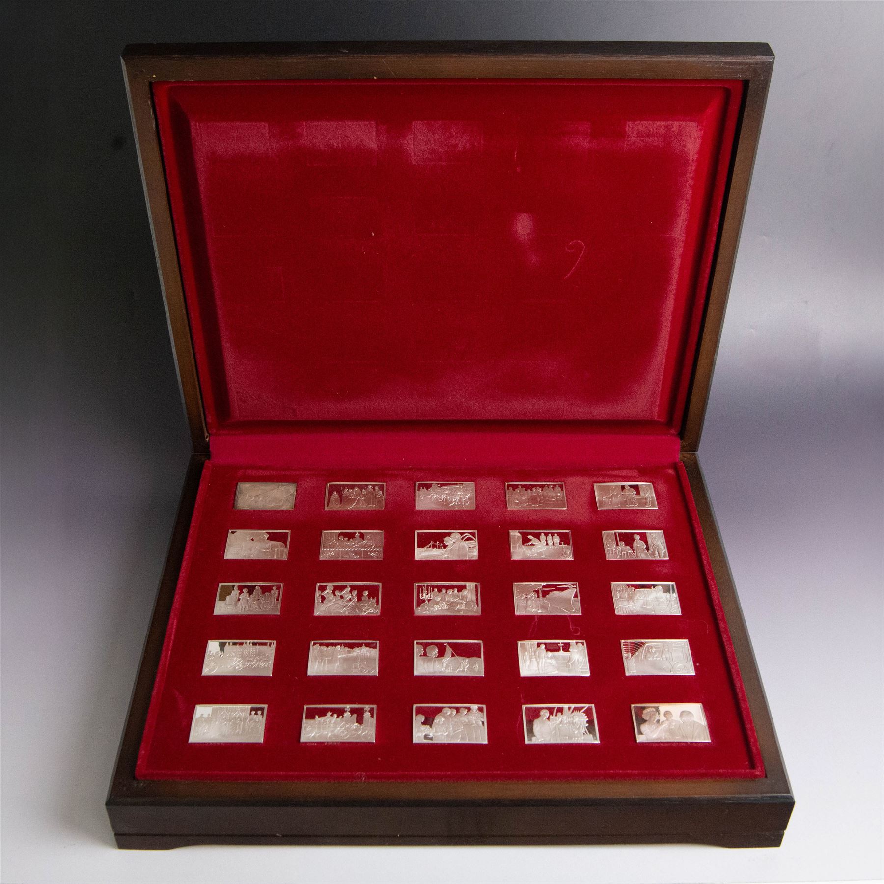 Elizabeth Our Queen silver ingots collection, twenty-five rectangular ingots each decorated in relief with a Royal scene, hallmarked John Pinches Ltd, London 1976, in wooden presentation case with information booklet