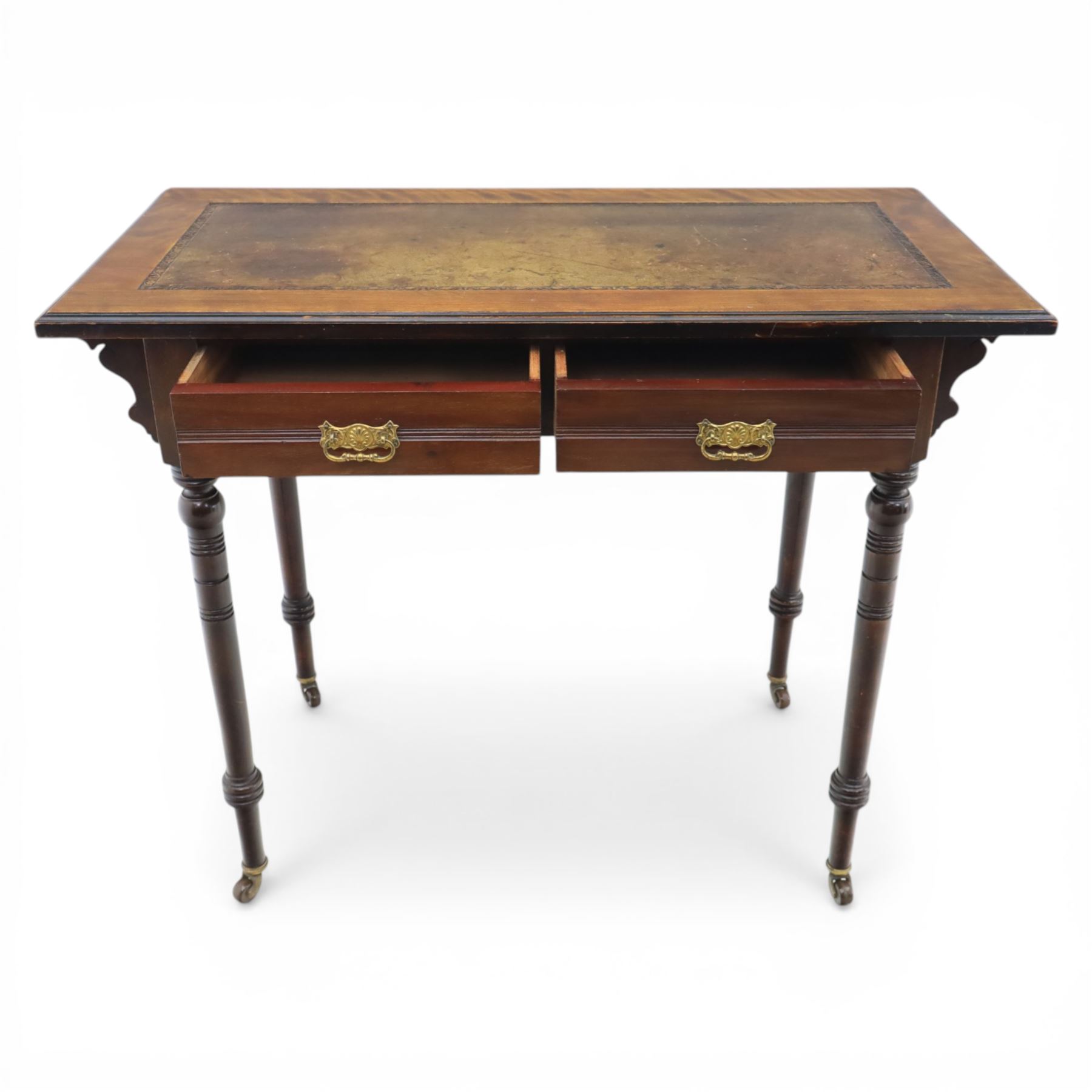 Edwardian mahogany writing table, tooled leather top over two frieze drawers, on turned supports terminating in castors
