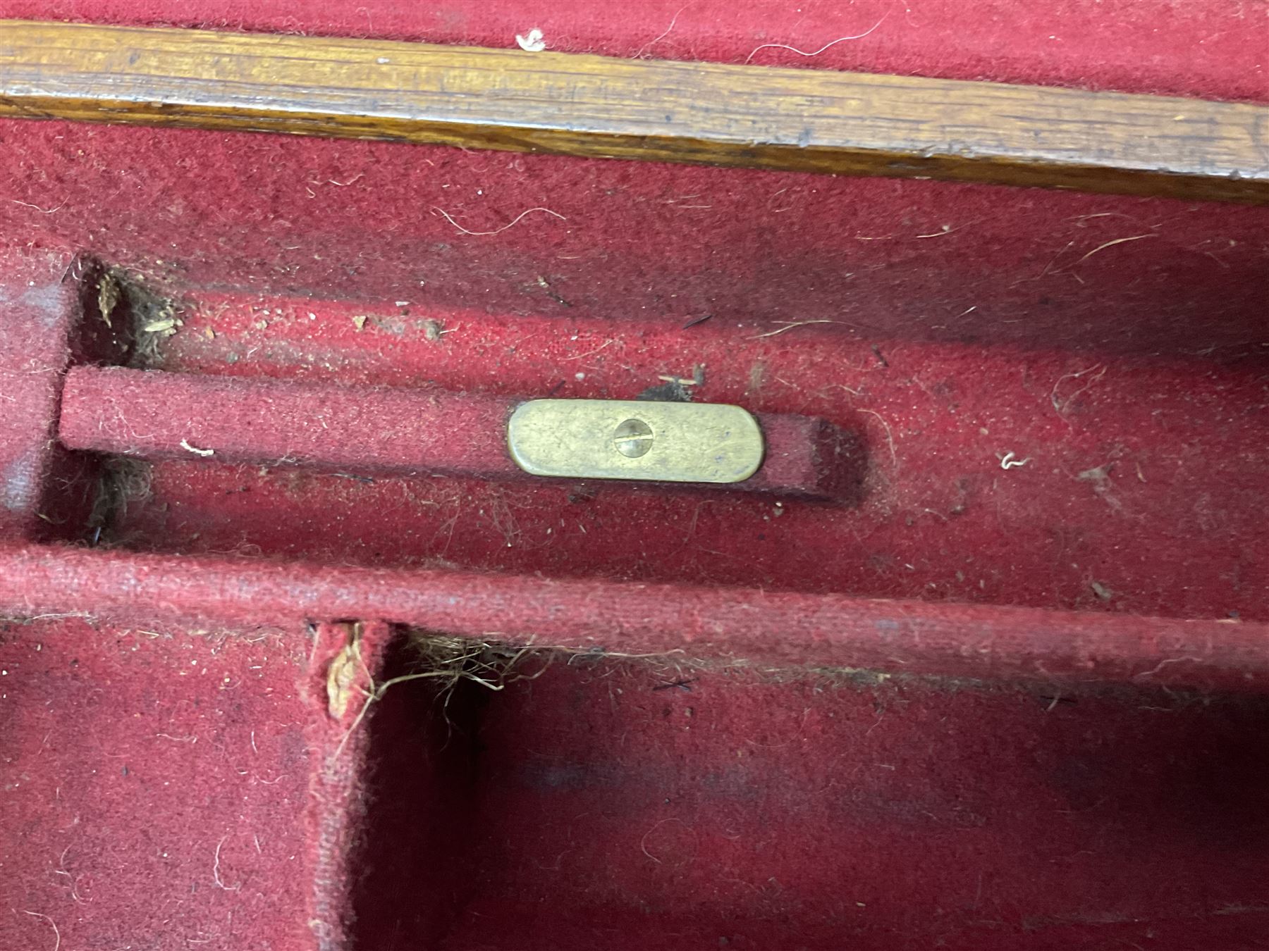 Leather shotgun case, the red baize lined interior with the trade labels of Westley Richards & Co., London, a brass plaque inscribed 'T Nevin, Mirfield, Yorkshire' to cover, with key, case to fit barrel 76cm (30 inches)  
