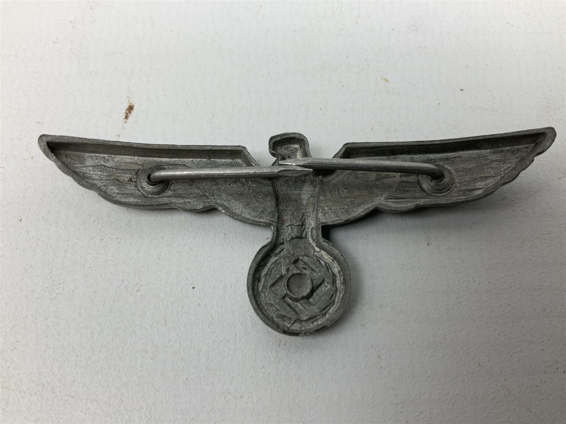 Five WW2 German peaked cap badges, four with double-pinned backs