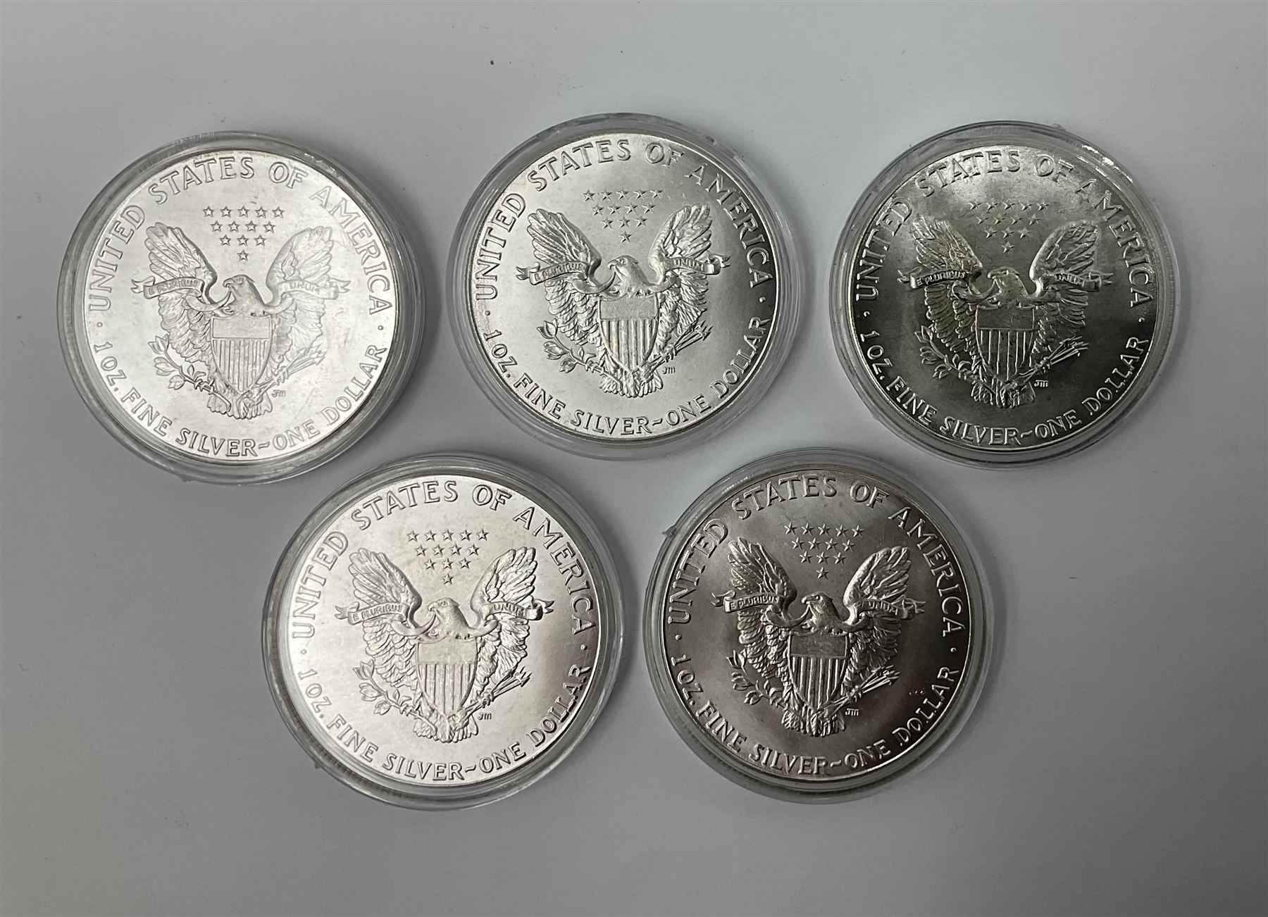 Five United States of America 1oz fine silver one dollar coins, dated 1986, 1987, 1988, 1989 and 1990