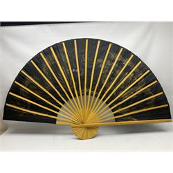 Chinese fan of large proportion decorated with gilt dragons on black ground, L90cm