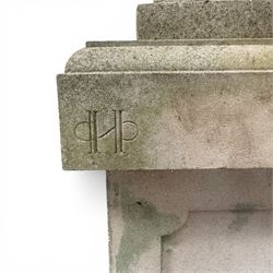 Pair of weathered cast stone Neoclassical design garden Kylix shape urns, foliate moulded rim over a gadrooned underbelly, the scalloped socle over a rectangular pedestal with faux-panelled sides, stamped with stylised ‘H’ monogram