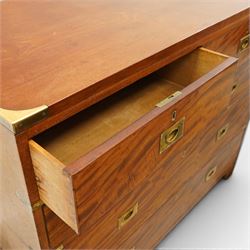 19th century figured mahogany military campaign chest of drawers in two sections, the rectangular top with brass-bound corners over two short and three long graduated drawers, each fitted with recessed brass campaign handles and escutcheons, the carcass with brass strapwork and carrying handles to the sides, raised on short bracket feet