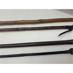 Two late 19th century fruit picker canes, the first example a French ebonised bamboo cane, with pair of fruit scissors to base, the handle stamped Cueille Fruit, the second example with grabbing action, the cap stamped A C Harris, Leicester, together with two other 19th century canes, one with fork and the other with hoe