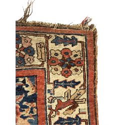 Persian Bidjar indigo ground rug, the busy field decorated with large floral motifs, the guarded ivory border adorned with repeating flower heads and stylised leaves