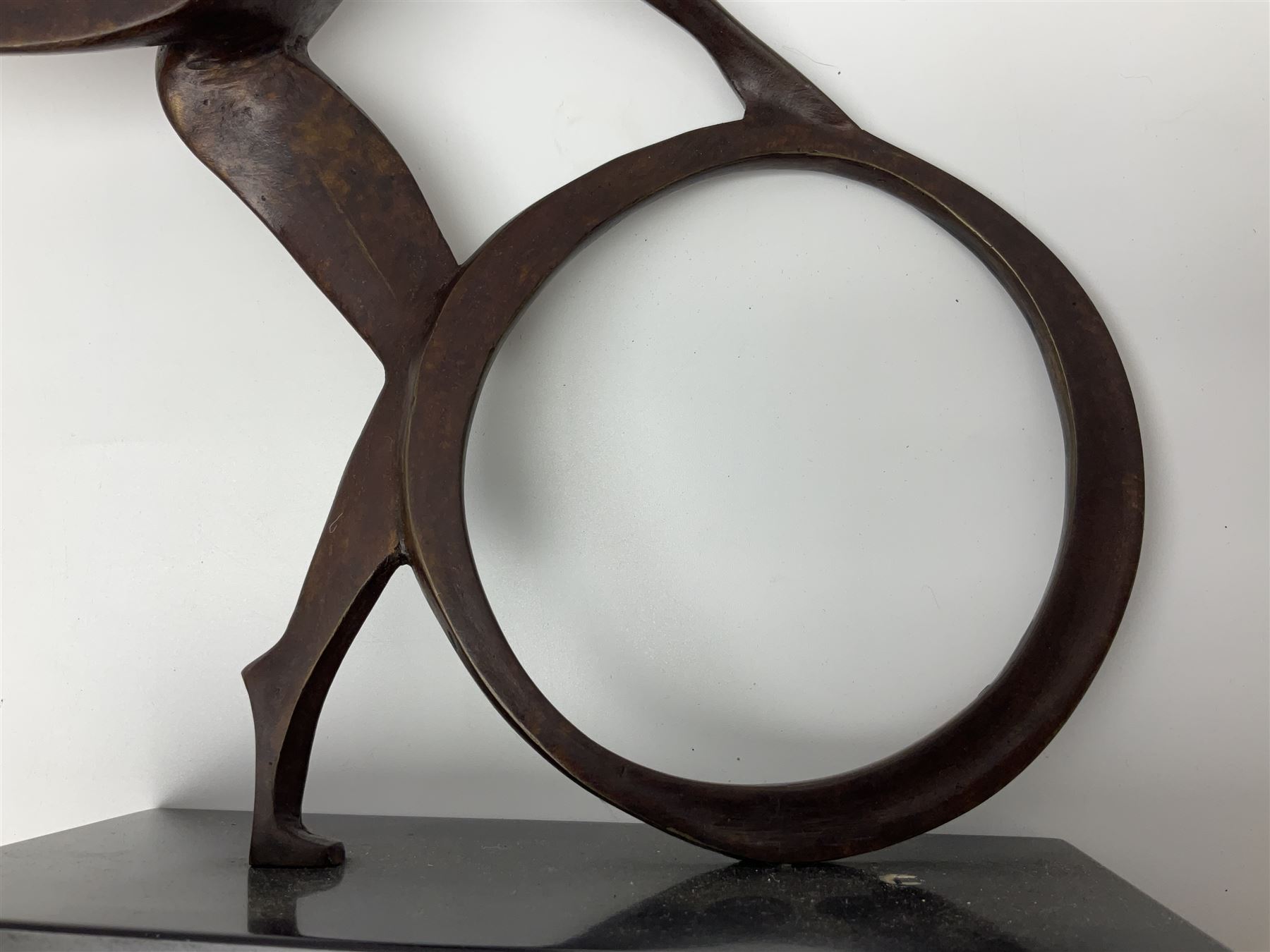 John Huggins FRBS (British 1938): 'Girl with Hoop', bronze sculpture upon black lacquered wooden base, H33cm, artist resale rights apply