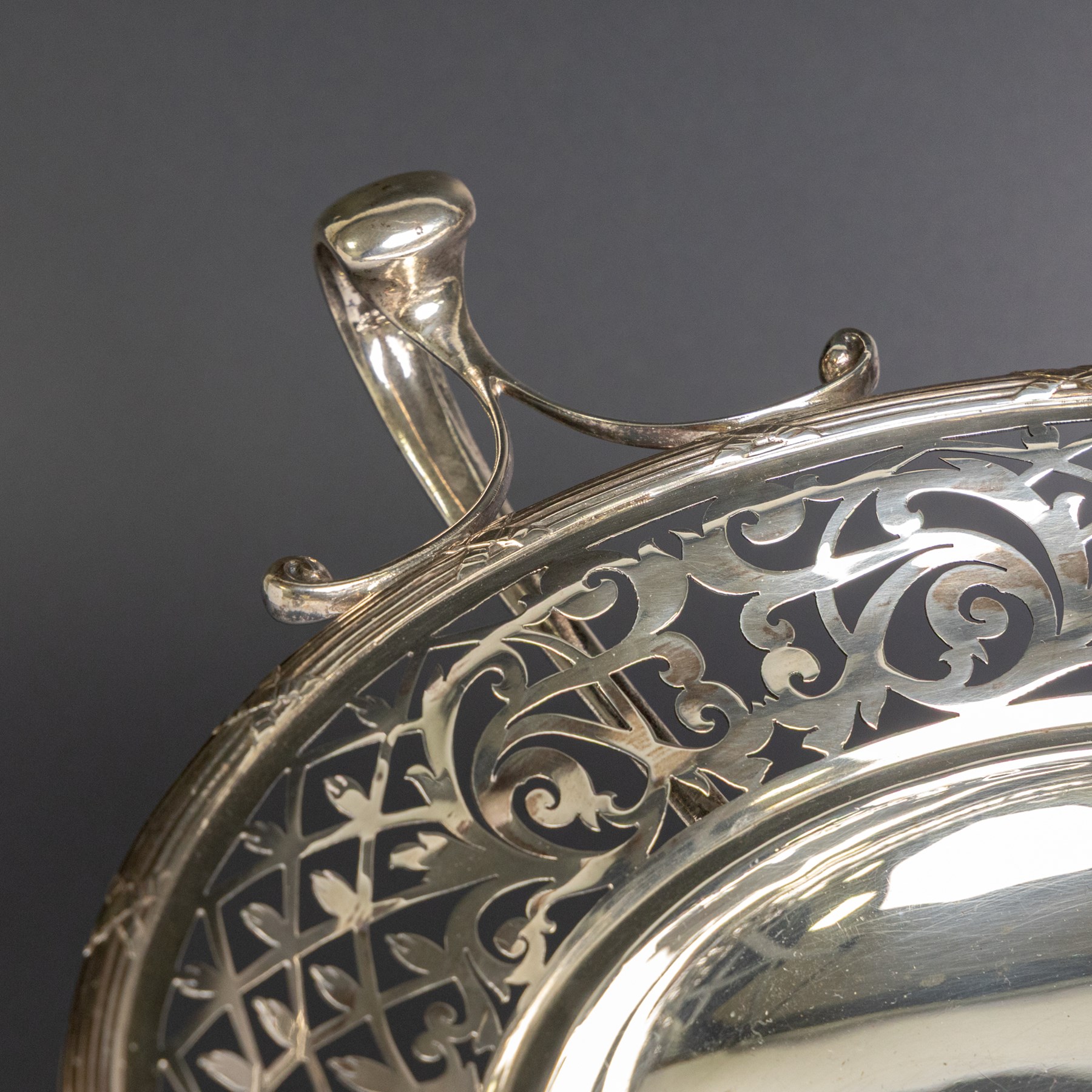 Early 20th century silver twin handled tazza, the bowl of circular form with pierced foliate decoration and ribbon and reed border, with two whiplash curved handles, upon a knopped stem and pieced foliate foot, hallmarked Walker & Hall, Sheffield 1911, H20cm