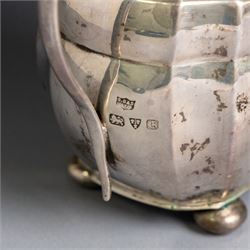1930s silver three piece tea service, comprising teapot, milk jug and open sucrier, of oval form, the teapot with ebonised handle and finial, hallmarked S Blanckensee & Son Ltd, Chester 1931
