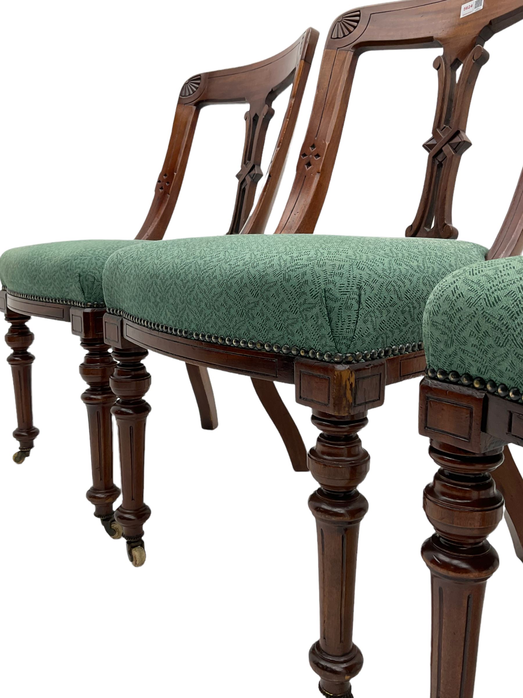 Set of four Victorian mahogany spoon back dining chairs, upholstered seats