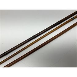 Early 20th century bamboo sword stick with 39cm oblong section blade L85cm overall; and two malacca cane swagger sticks, one with white metal mounts the other with yellow metal mounts (3)