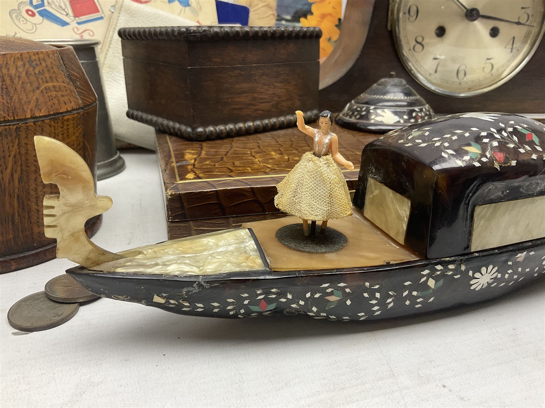 Mid 20th century cigarette box in the form of a gondola, the faux tortoiseshell with mother of pearl inlay (a/f), cased mantel clock with silvered numerical dial, oak lidded tea jar caddy, oak box, silver-plate cutlery, quantity of records, Smith's empire miniature clock, stamps etc
