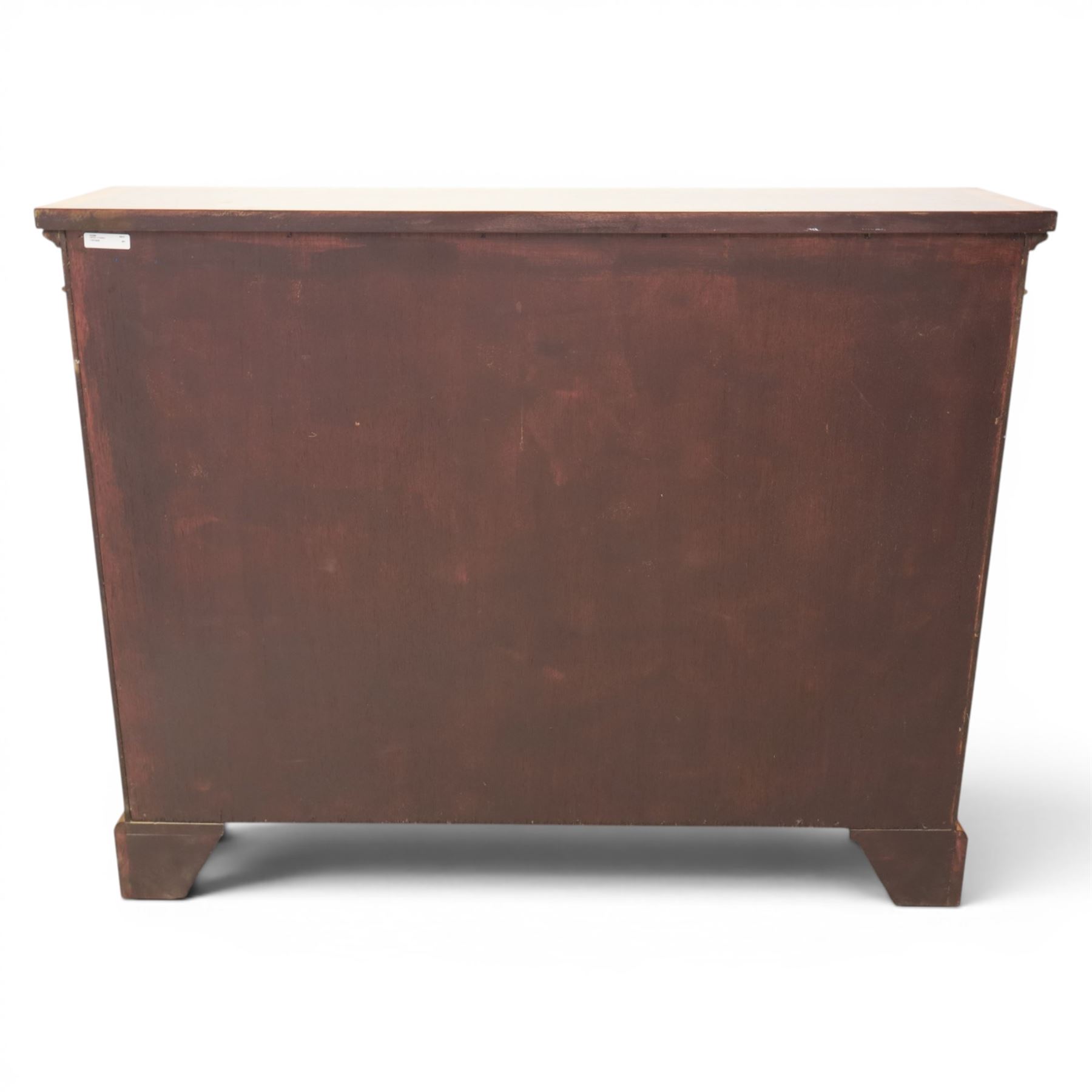 Traditional walnut small bookcase, with projecting cornice above a green painted interior, adjustable shelving, on a moulded plinth base