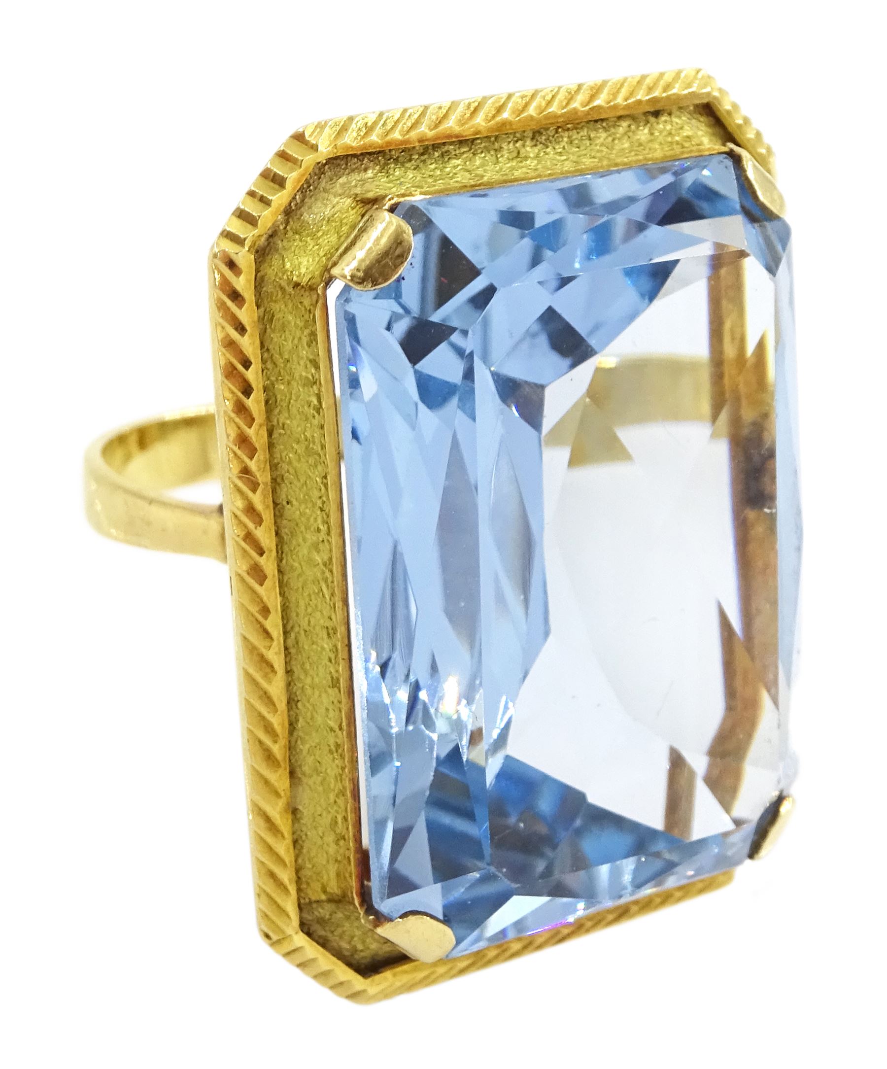 Gold synthetic spinel ring, single octagonal cut synthetic spinel with textured and engraved border