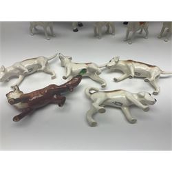 Beswick hunting group, comprising huntswoman on grey horse no 1730, huntsman on brown horse no 1501, fox figure no 1440 and eight fox hounds, all with printed marks beneath (11)