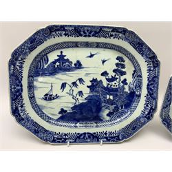Two late 18th/early 19th century Chinese export blue and white platters, of canted form, decorated with a landscape set with pagodas and sailboat between islands, within diaper and foliate, moth, and stylised key border, largest example W36cm, smaller W32cm