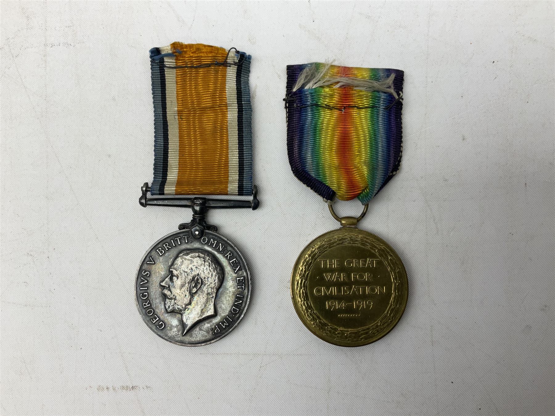 Three WW1 medals comprising 1914-15 Star awarded to 58648 Spr. C. Roberts R.E.; British War Medal and Victory Medal awarded to 87502 1.A.M. C. Roberts R.F.C.; and REME cap badge (4)