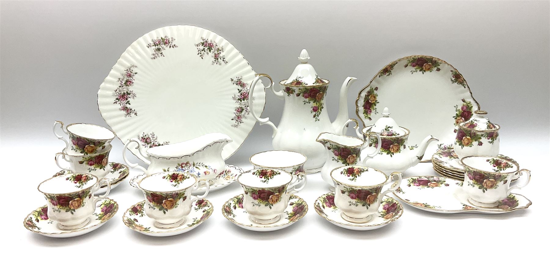 Royal Albert Old Country Roses pattern tea set, comprising teapot, coffee pot, six teacups and six saucers, five side plates, further teacup with joined saucer and side plate, open sucrier, milk jug, cake plate, and preserve pot and cover, together with Royal Albert Jubilee Rose pattern sauce boat and stand, and Royal Albert Lavender Rose pattern cake stand. 