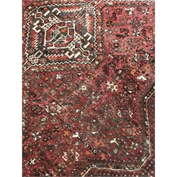 Large Persian red ground rug/carpet, the field decorated with multiple stylised motifs and quadruple pole medallion, six band repeating border, 314cm x 226cm