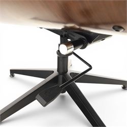 In the manner of Eames' Lounge chair, contemporary brown leather and plywood recliner and footstool, padded leather seat and arm rests, plywood backs raised on a black metal frames, reclines and swivels on a five point base  