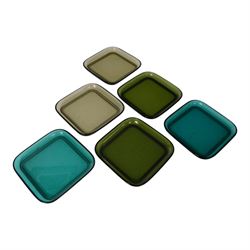 Mid century Finnish red glass bottle, designed by Nanny Still for Riihimaen Lasi, of square sided form with tall neck, H21.5cm, together with set of six mid century Finnish glass plates, designed by Kaj Franck, in smokey green, olive green and turquoise green, 13.5cm x 13.5cm