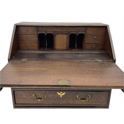 Georgian oak bureau, fall front enclosing fitted interior, four long graduating drawers, on bracket feet
