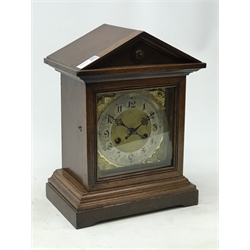  Edwardian oak architectural cased bracket clock, silvered Roman dial with twin train movement half hour striking on a coil, H34cm, W28cm, D17cm   