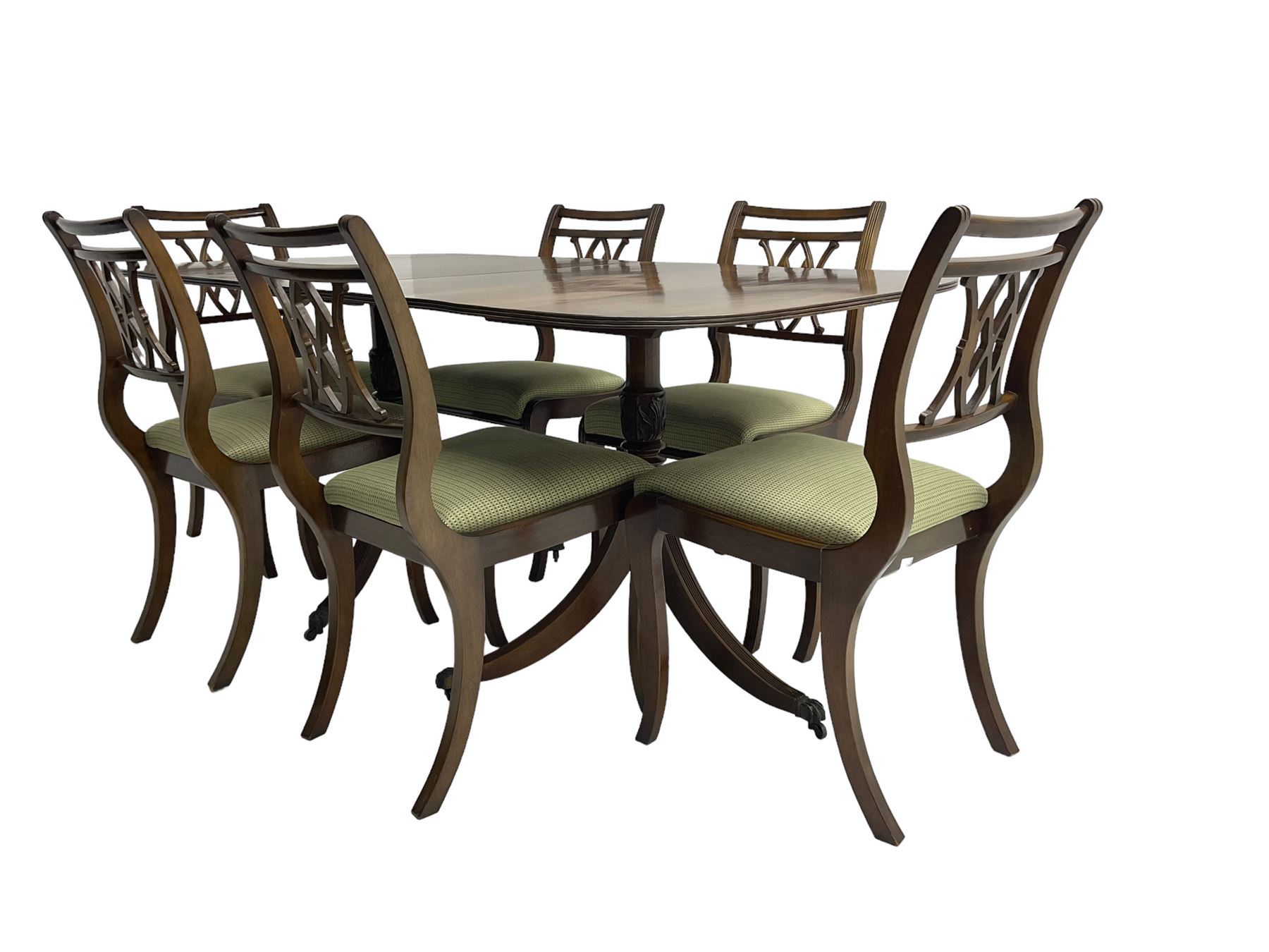 Regency design mahogany twin pedestal dining table, rectangular top with reeded edge, acanthus carved turned column terminating in reeded tripod base with hairy paw feet and castors (W172cm D92cm H75cm) and set eight (6+2) Regency design mahogany dining chairs, pierced back with scroll design, seat upholstered in patterned laurel green fabric, raised on reeded sabre supports (W48cm H88cm)