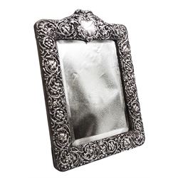 Edwardian silver mounted dressing table top mirror, of rectangular form, the frame embossed with vacant reserve, flower heads and foliate scrolls, with easel style support verso, hallmarked Henry Matthews, Birmingham 1905, overall H32cm W23cm
