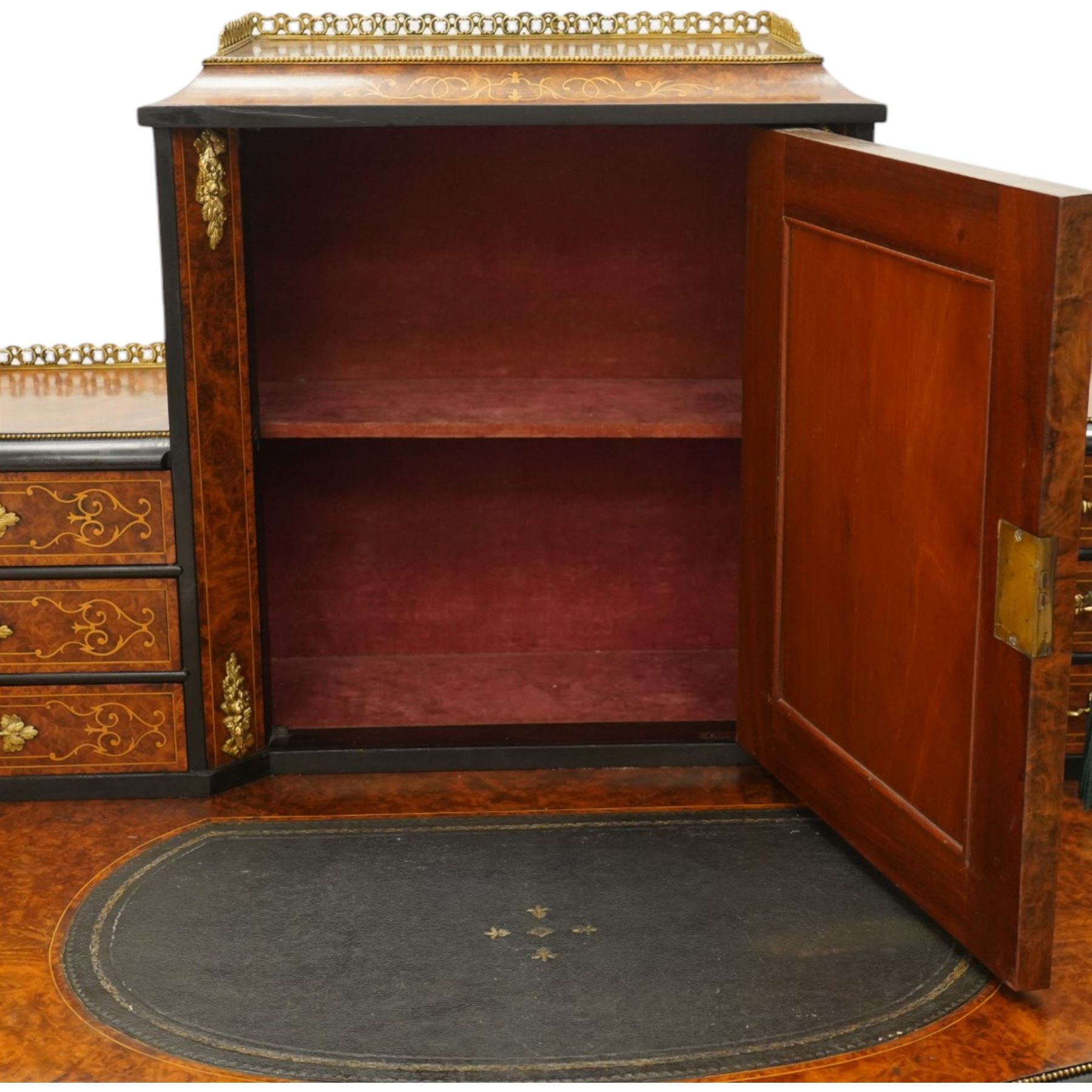 19th century French inlaid figured walnut and ebonised Bonheur de Jour or writing desk, the raised upper section with pierced brass three-quarter gallery, over a mirror glazed cupboard and a combination of drawers, the shaped and moulded top with leather inset and satinwood stringing, with brass beading too the ebonised edge, fitted with a serpentine fronted frieze drawer, raised on cabriole supports, inlaid throughout with scrolling foliate decoration in boxwood and ornate cast brass mounts and handles