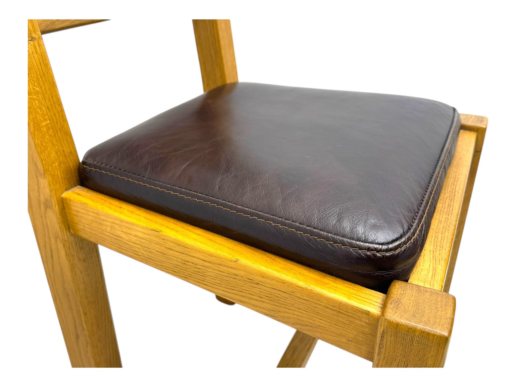 Contemporary oak dining table, rectangular panelled top with integral extension leaf, raised on square supports; set of four oak ladder-back chairs with padded brown seats