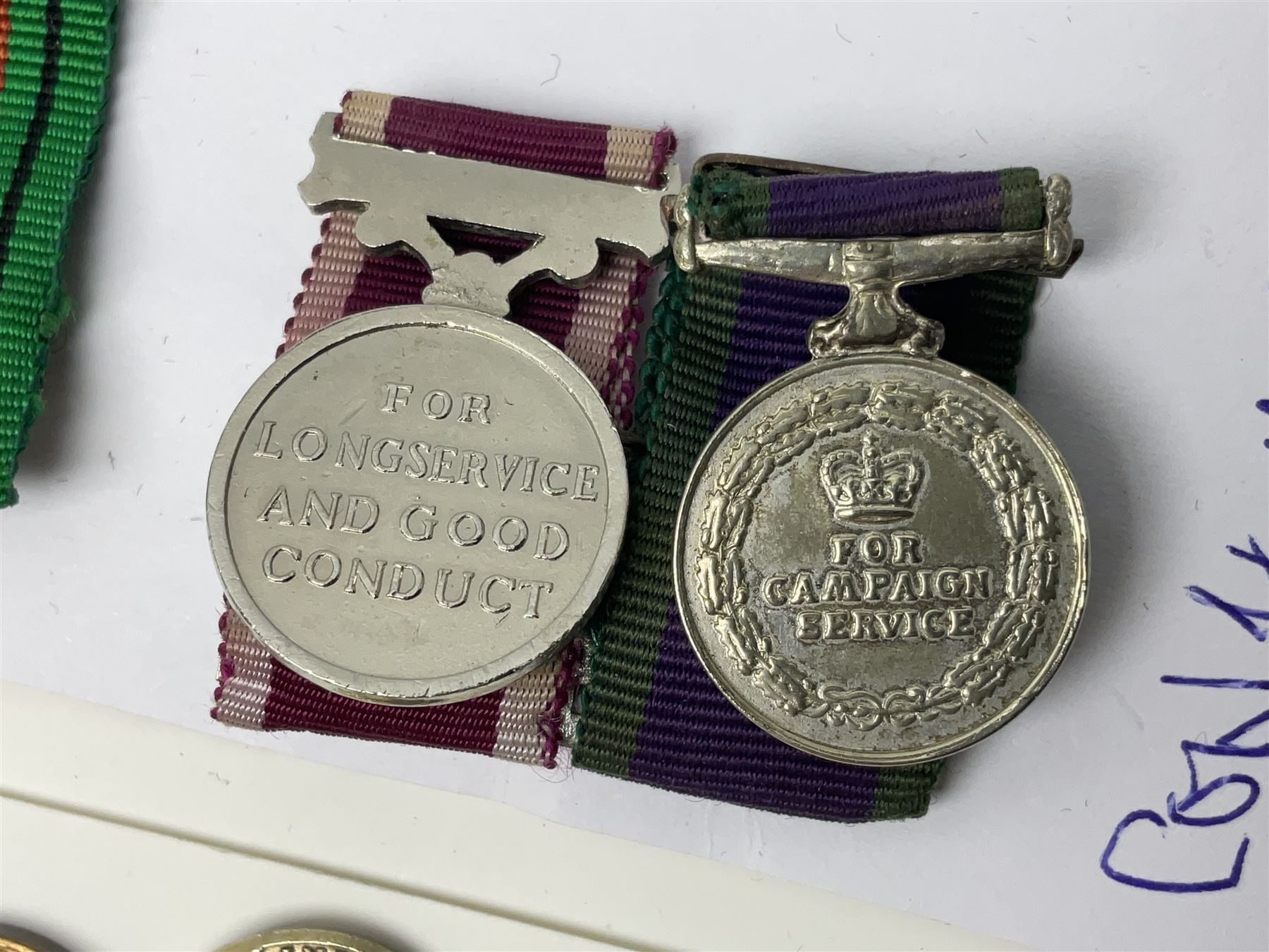 Eleven medal miniatures including Turkish Crimea, OBE (Civil), WW2 Burma Star and France/Germany Star, two pairs of WW2 War/Defence medals, LSGC etc; and two military badges