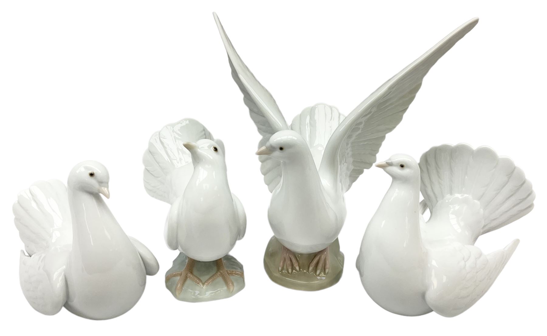 Four Lladro dove figures, comprising Taking Flight no 6288, Dove no 1015, Proud Dove no 6290 and Peaceful Dove no 6289, all with original boxes, largest example H20.5cm 