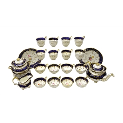  Early 19th century tea service for eight persons, moulded gilt rim, floral hand painted panels on cobalt blue ground, comprising teapot, sucrier, eight cups and saucers, eight tea cups & two serving plates c1830-40   
