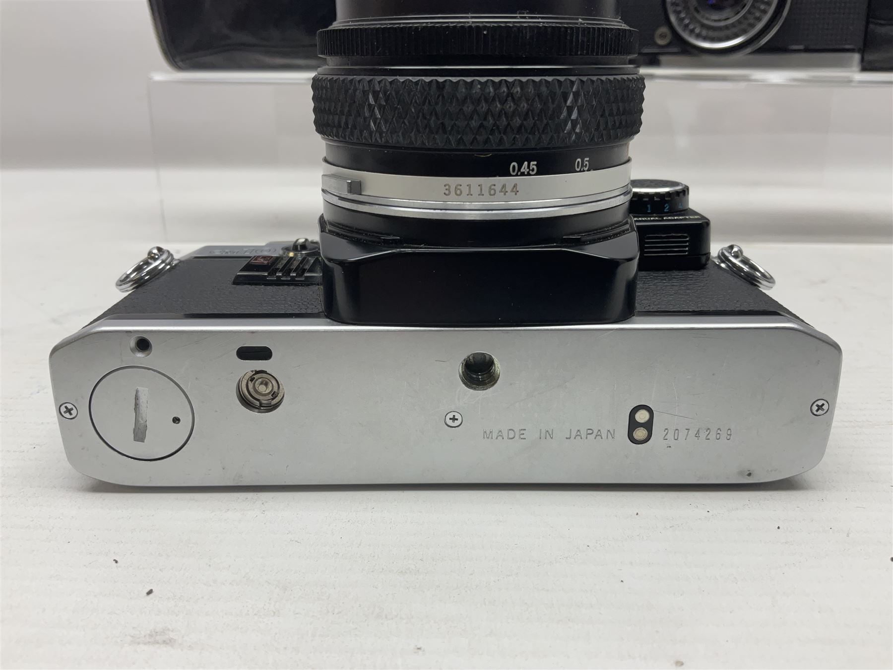 Four Olympus camera bodies, including Olympus OM10, serial no 20744269, with 'Olympus OM-System Zuiko Auto-S 50mm 1:1.8' lens serial no 3633644, Olympus OM-2 camera body serial no 460280 with 'Olympus OM-System G.Zuiko Auto-s 1:1.4 f=50mm' lens, serial no 729750, etc 