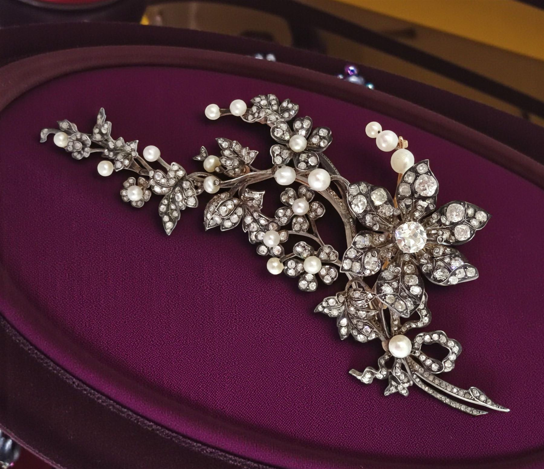 19th century gold and silver diamond and pearl en tremblant detachable brooch, the flower tremblant with a principal old cut diamond of approx 1.90 carat, the petals and stamen set with old cut and rose cut diamonds, total diamond weight approx 9.10 carat, to a foliate spray set set with further rose cut diamond and white / pink / cream pearls and ribbon tie
