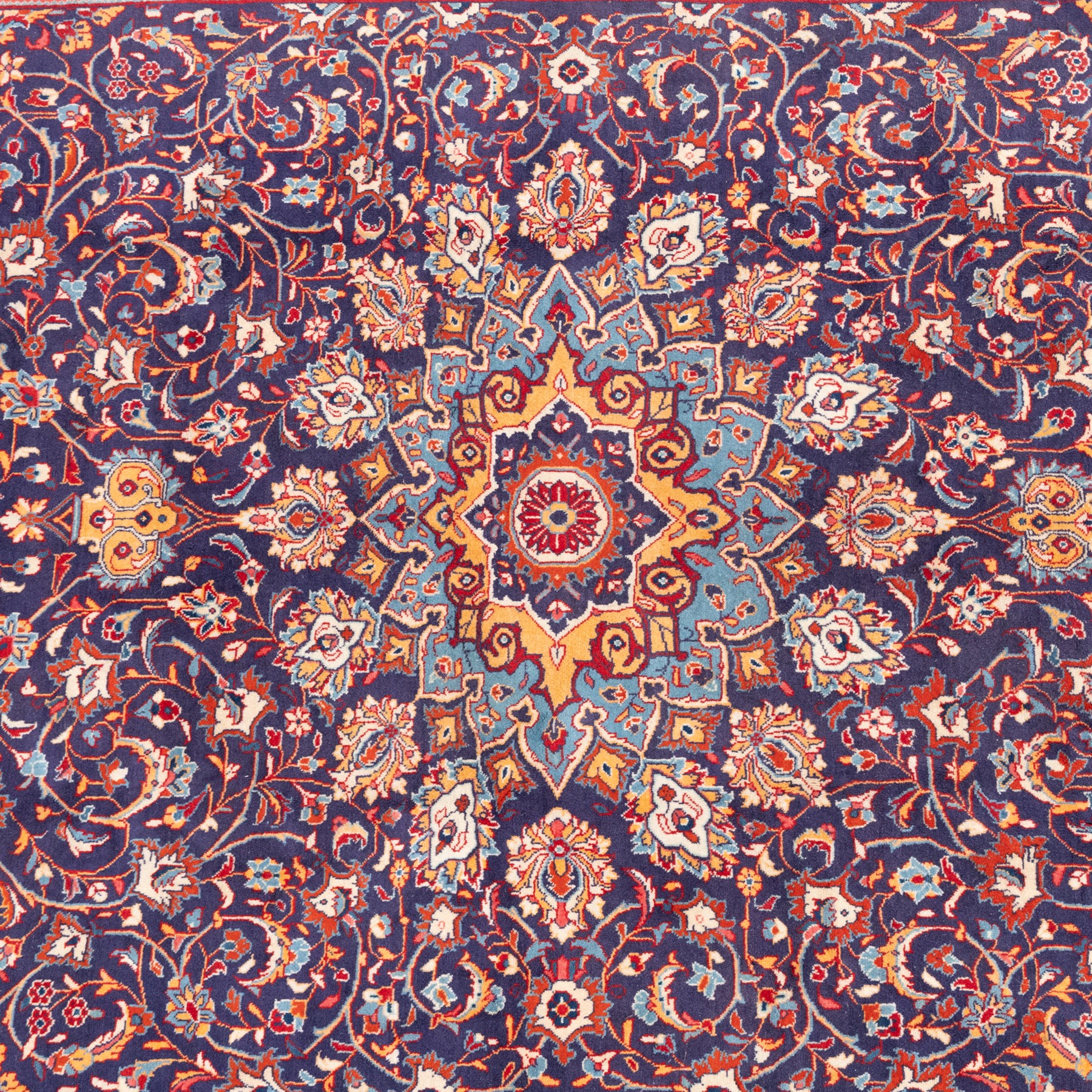 North West Persian carpet, the indigo field centred by a lobed medallion in pale blue and ochre with floral pendants, profusely decorated with scrolling foliage, palmettes and flowerheads, ivory floral spandrels, enclosed by a red ground palmette border and multiple floral guard bands