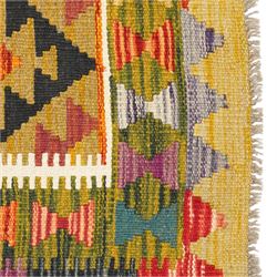 Afghan Maimana flatweave kilim runner, central field features large bold nested diamond motifs and stylized geometric lozenge patterns on olive purple, blue, and green tone ground, border stripe in mustard ground, and fringe