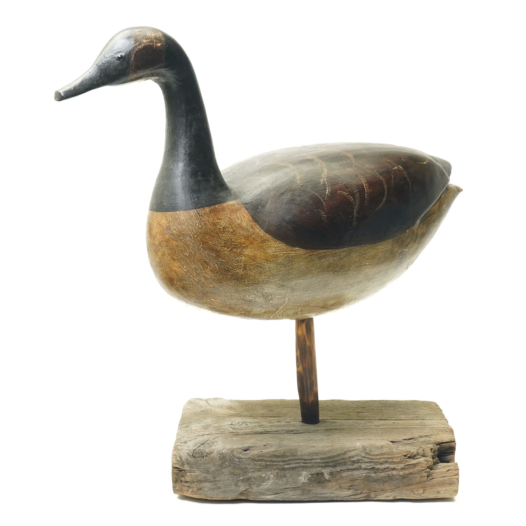 Guy Taplin (British 1939-): 'Canada Goose', carved and polychrome painted wooden sculpture of a bird, on a naturalistic driftwood base, H64cm
Provenance: purchased directly from the artist in the 1990s