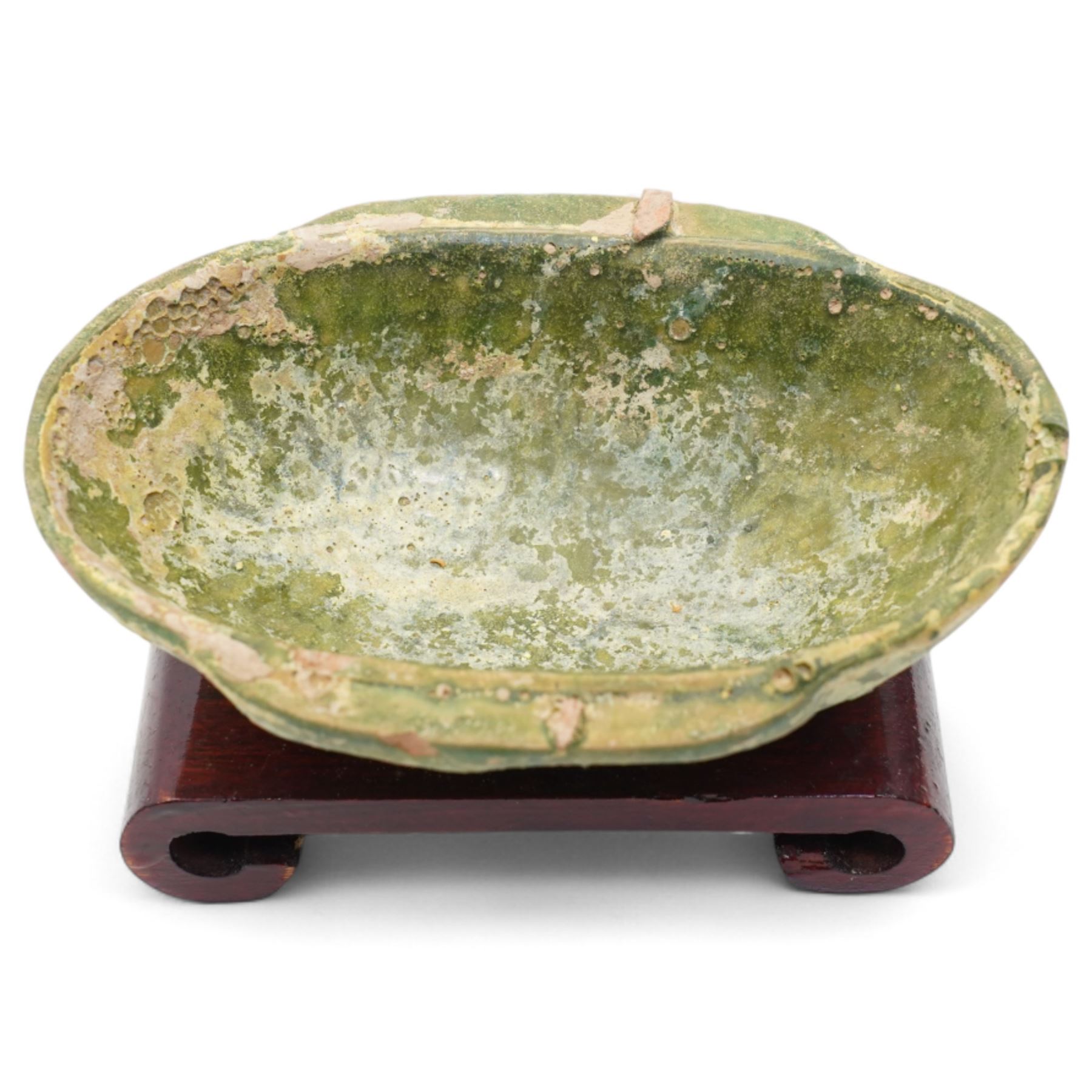 Two small Chinese terracotta 'ear' shaped wine cups, probably Western Han Dynasty c.206BC-24AD, one with green glaze, each on hardwood stand, W12cm (2)