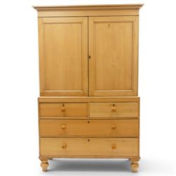 Victorian stripped pine housekeepers cupboard, projecting cornice over two panelled cupboard doors enclosing two shelves, the base fitted with two short over two long graduating drawers, lower moulded edge over turned feet