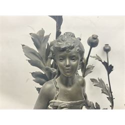 Pair of Art Nouveau style spelter figural table lamps, each mounted on rouge marble effect circular bases, with toleware flower heads and leafy decoration surrounding a female figure, H90cm