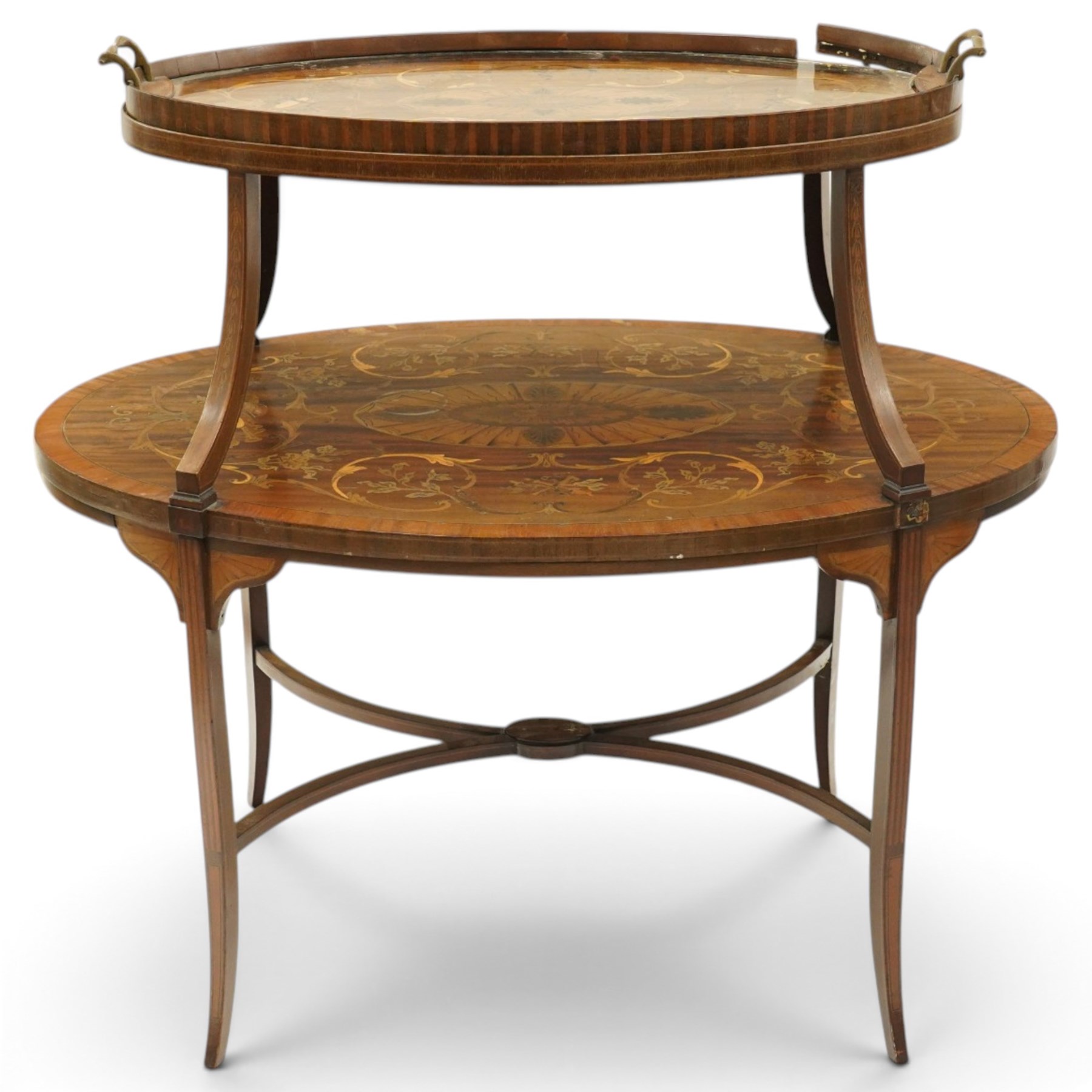 Edwardian Sheraton Revival inlaid mahogany and satinwood marquetry oval two-tier étagère occasional table, the oval top with removable glazed tray with brass handles, over an ornately inlaid top with central patera motif and trailing foliate scrolls, the splayed uprights inlaid with bellflowers, over a matched inlay under-tier, raised on splayed supports united by curved X-stretcher,  retailed by David Hick Interiors, Jersey