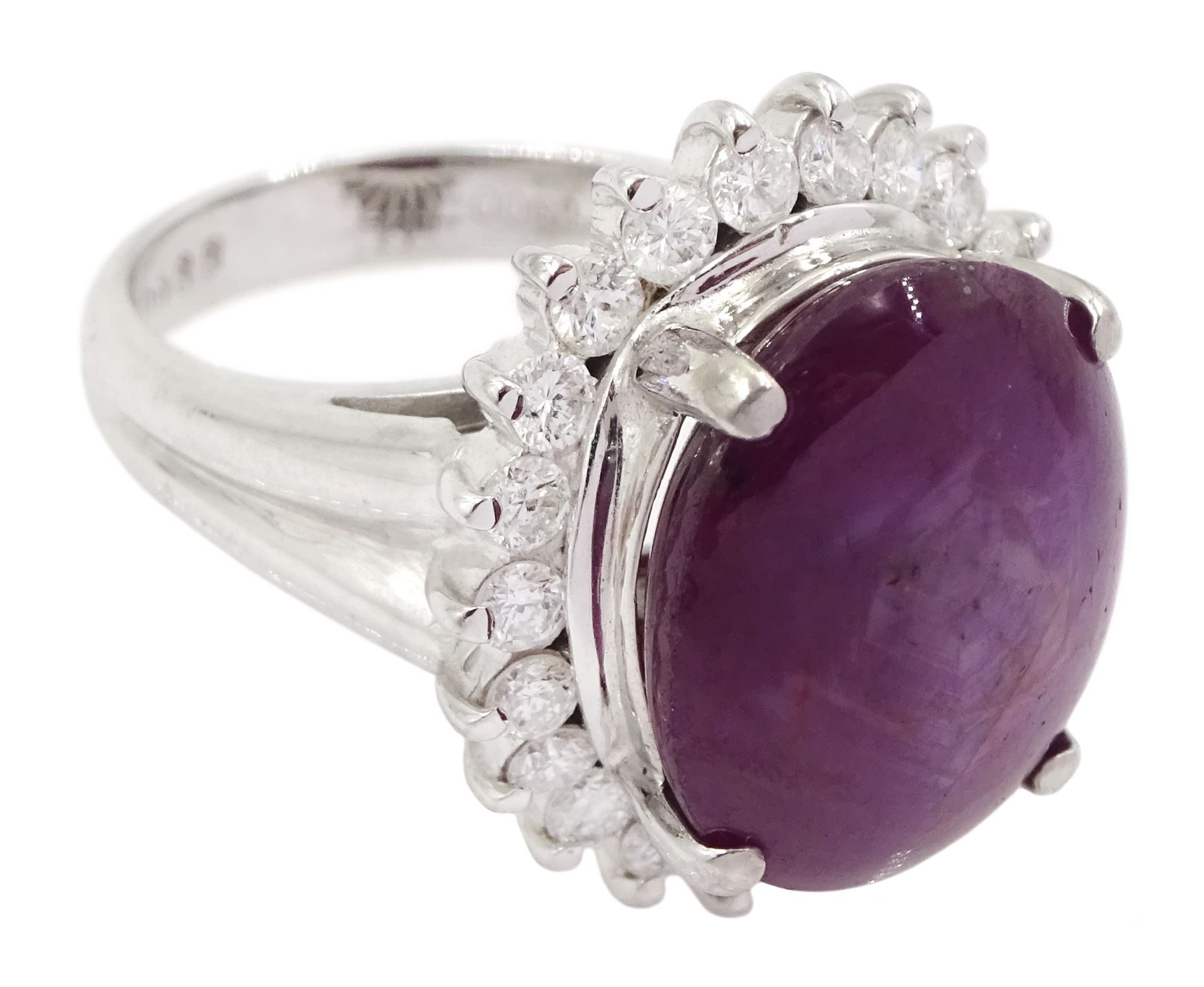 Platinum cabochon star ruby and round brilliant cut diamond cluster ring, stamped Pt900, ruby 12.57 carat, total diamond weight 0.88 carat