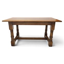 Titchmarsh & Goodwin style solid oak refectory table, rectangular top raised on block and turned supports united by a full length undertier