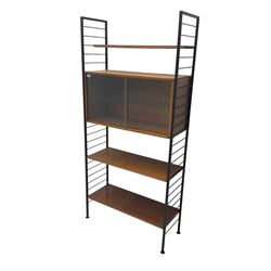 Staples Ladderax - mid-20th century teak and metal framed modular wall unit, fitted with central cupboard, the sliding glazed doors enclosing single shelf, flanked by three adjustable shelves 