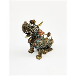 A 20th century Chinese filigree brass model of a Foo Dog, with  turquoise and coral roundels and lozenges, H11.5cm. 