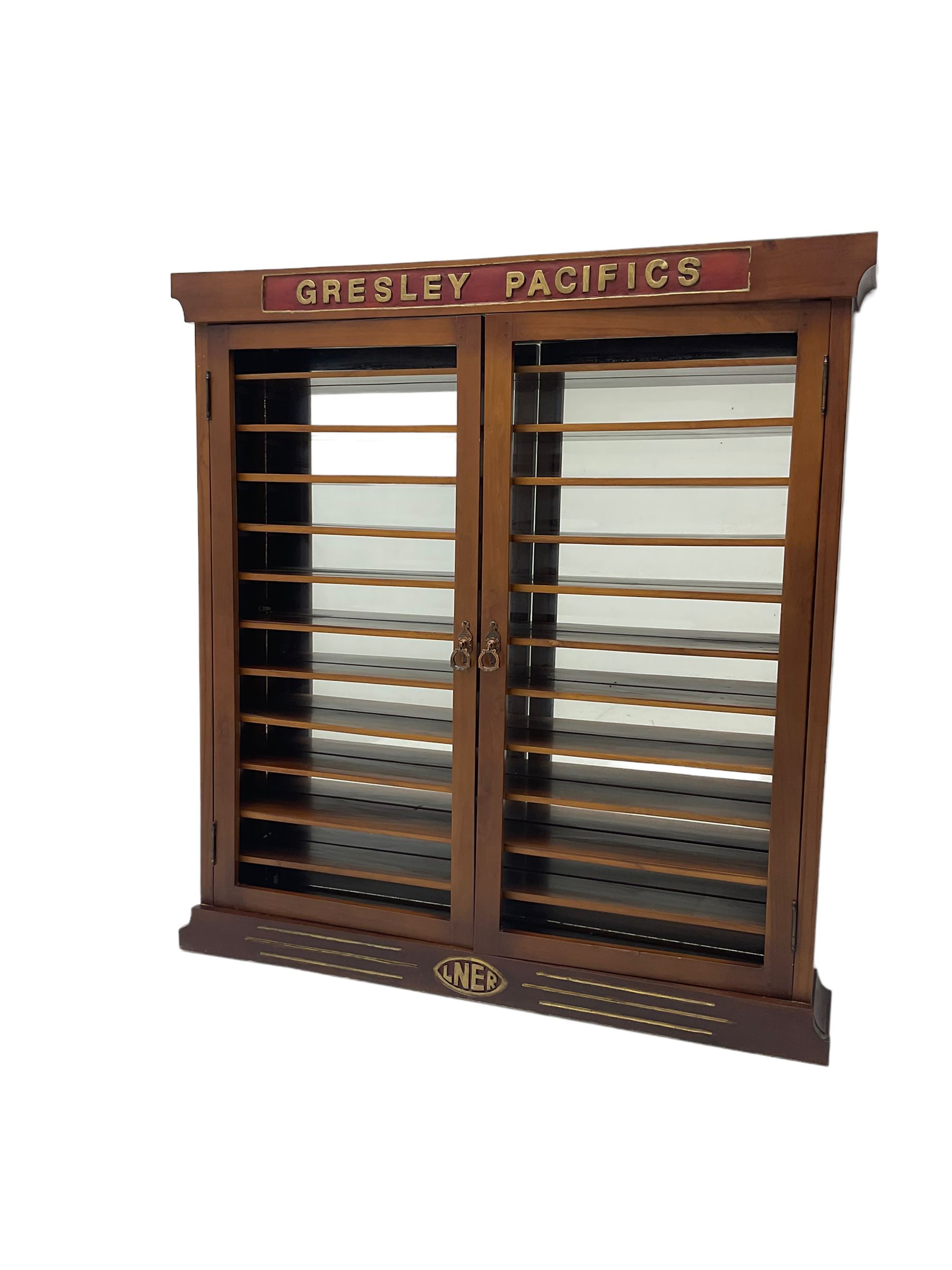 Modern hardwood display cabinet for model railway locomotives inscribed 'Gresley Pacifics' to the frieze and 'LNER' to the bottom rail; with mirrored back and ten loose fitting shelves enclosed by a pair of unglazed doors L101cm H108cm D16cm