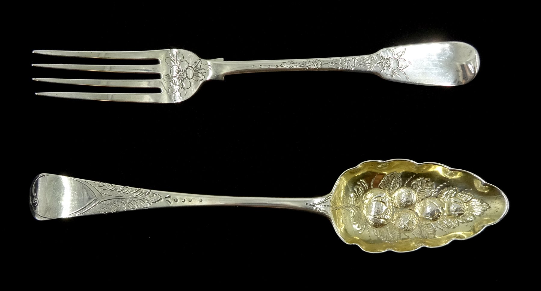 George III silver berry spoon by Solomon Hougham, London 1801 and a George III silver fork, fiddle pattern with bright cut floral decoration by Thomas Wilkes Barker, London 1805, approx 4.5oz